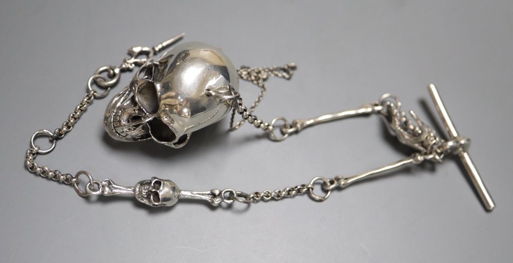 A sterling novelty skull locket?, on a skeletal albert chain, 32.5cm, gross 54 grams.